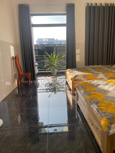 a bedroom with two beds and a room with a window at Habi Homestay Doc Let in Phú Thọ