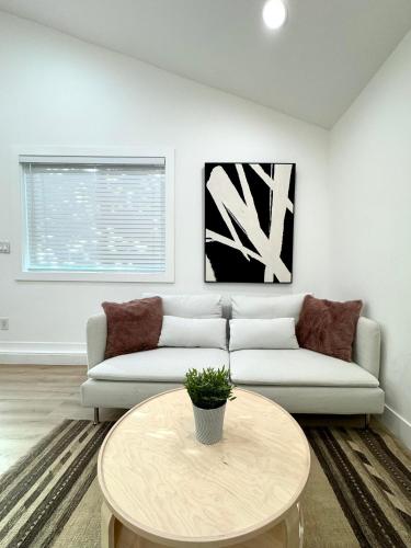 a living room with a couch and a table at Modern and Cozy Private Studio in Lynnwood