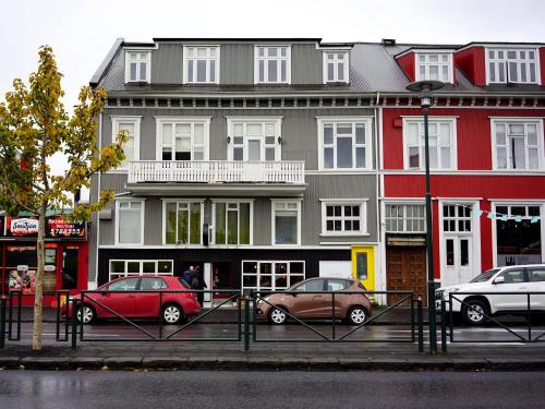 a group of cars parked in front of a building at Downtown Guesthouse Reykjavik in Reykjavík