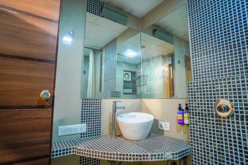 a bathroom with a sink and a mirror at Hotel Crown in Ahmedabad