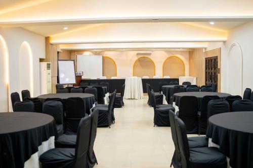 a conference room with black tables and chairs at Road Sewa in Bākhri Kharka