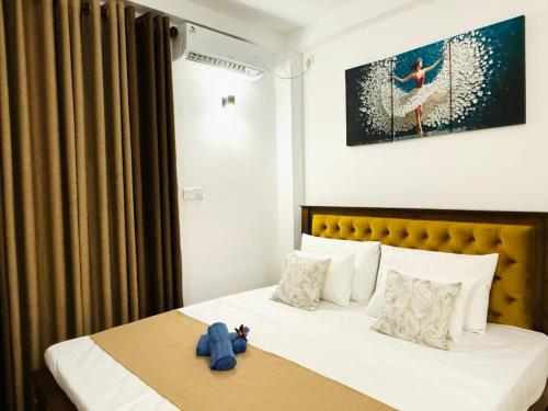 a bedroom with a bed with a teddy bear on it at Roo Ceylon Beach Villa in Matara