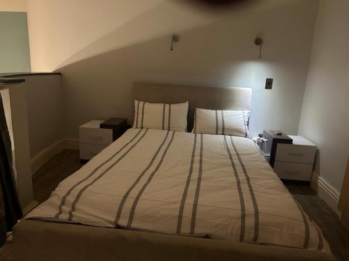 a bedroom with a large bed with two night stands at 312 Mutual Heights Building in Cape Town