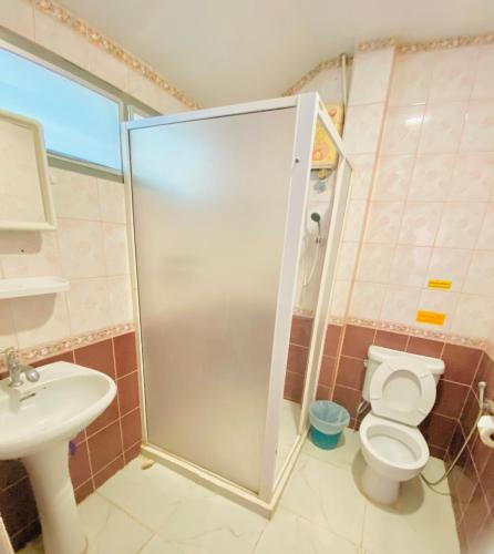 a bathroom with a shower and a toilet and a sink at Baan Golden Resort & Residences in Sam Roi Yot