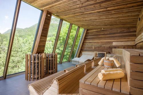 a room in a tree house with large windows at Vivea Hotel Bad Bleiberg in Bad Bleiberg