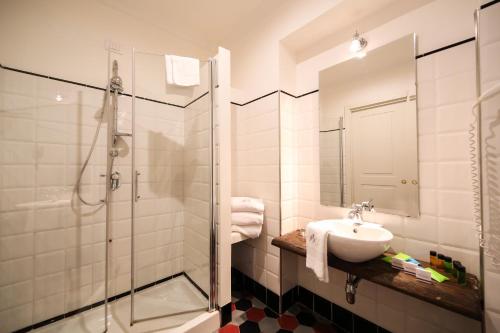 a bathroom with a sink and a glass shower at Decumani Hotel De Charme in Naples