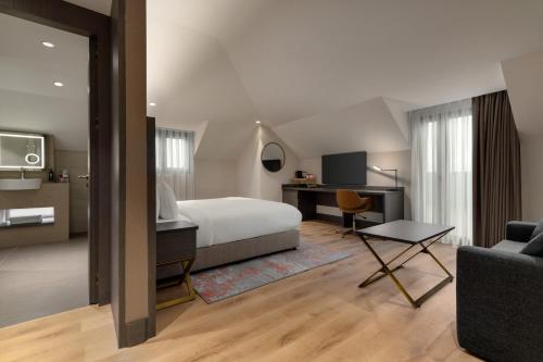 a hotel room with a bed and a desk at Ramada by Wyndham Arnavutkoy in Istanbul