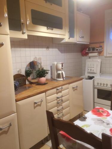 a kitchen with white cabinets and a table with a table at Chez Violette in Destry