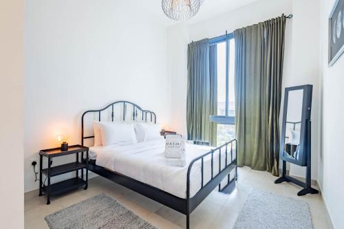a bedroom with a bed and a large window at Livin' Holidays - 3BR - Family Friendly Townhouse w Private Pool in Ras al Khaimah