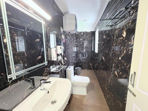 a bathroom with a sink and a toilet at Singalila Retreat by Barsana Group Darjeeling in Darjeeling