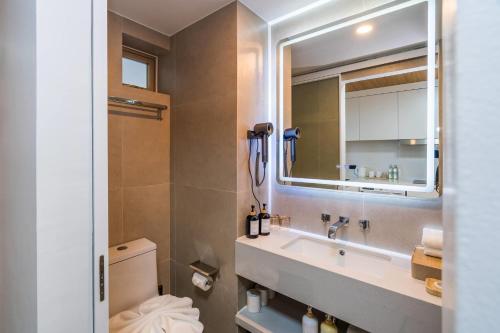 a bathroom with a sink and a mirror at Wyndham Garden Samui Wing in Chaweng