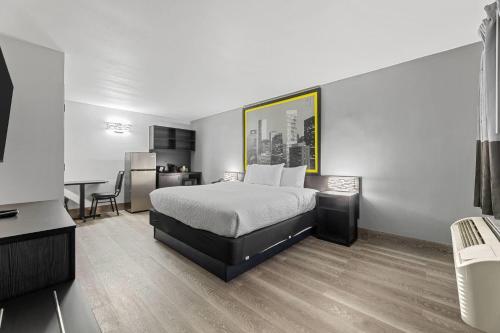 a hotel room with a bed and a desk at Super 8 by Wyndham Texas City - Galveston Area in Texas City