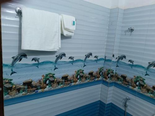a bathroom with a flock of birds on the wall at Diamond Blue Residency in Durgāpur