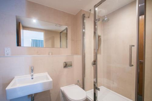 a bathroom with a sink and a toilet and a shower at Cleyro Serviced Apartments - Finzels Reach in Bristol