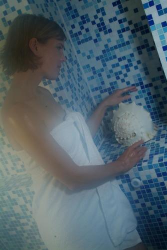 a woman in a white wedding dress holding a cake at Hotel Spiekeroog in Spiekeroog