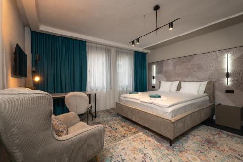 a hotel room with a bed and a chair at Къща Рустик in Belogradchik