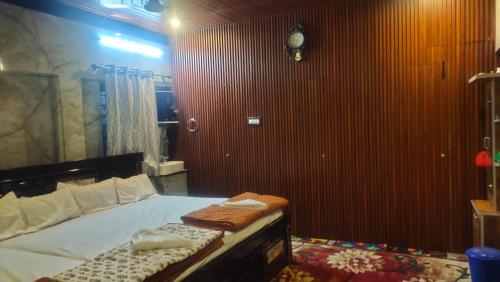 a bedroom with a bed with two towels on it at DD Gardens in Rāmeswaram