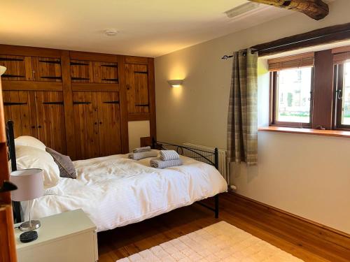 a bedroom with a bed and a window at Old Well Cottage Barn Conversion in Penrith