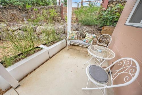 a patio with two chairs and a table on a porch at Cromwell Lite in Cooma