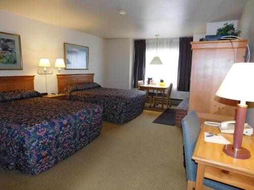מיטה או מיטות בחדר ב-Pacific Gardens Inn