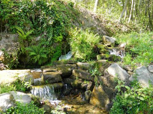 a stream of water flowing down a hill with rocks at Quinta Lamosa Agroturismo in Arcos de Valdevez