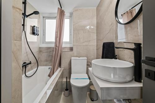 a bathroom with a sink and a toilet and a shower at Mnasiadou Suite 16 in Nicosia