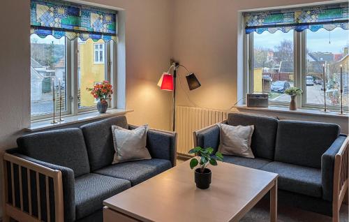 a living room with two couches and a table at Amazing Apartment In Hundested With Wifi in Hundested