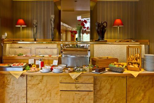 a kitchen with a counter with food on it at Landhotel Püster in Allagen