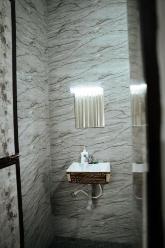 a bathroom with a sink and a mirror at Patnem Bliss in Canacona
