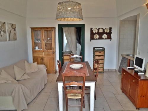 a living room with a table and a couch at Masseria Rosa Trulli Relais in Alberobello