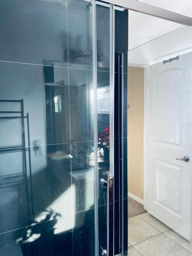 a glass cabinet in a room next to a door at Welcome to Shibly's Retreat in Edmonton