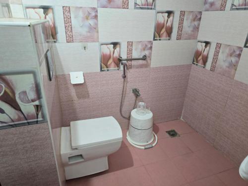 a small bathroom with a toilet and a sink at GT Homestay in Chennai