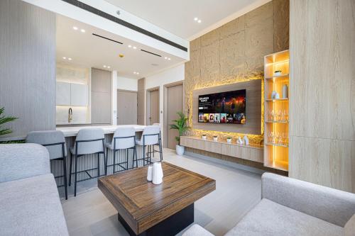a living room with a bar with a tv on a wall at Iconic Binghatti Royale! Private Pool in Your Balcony! 5 Star Amenities! in Dubai