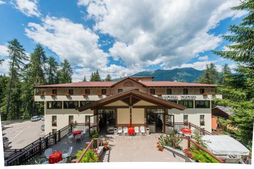a hotel with a patio in front of a building at Hotel Derby in Folgarida