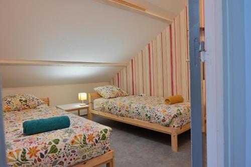a small room with two beds at La Champtocette de la Loire in Champtoceaux