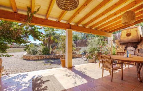 a wooden pergola with a table and chairs on a patio at Holiday Home Finca Ses Tanques in Algaida