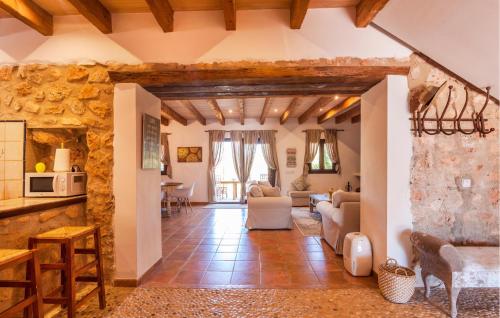 a large living room with a stone wall at Holiday Home Finca Ses Tanques in Algaida