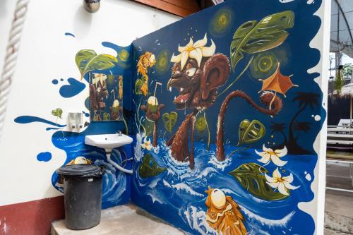 a bathroom with a painting on the wall at Mook Lanta Eco Resort in Ko Lanta