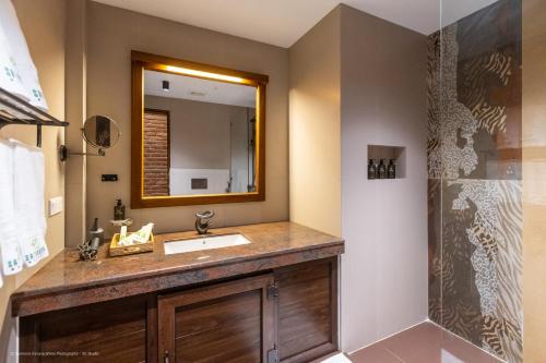 a bathroom with a sink and a mirror at Sathkara Resort Ella in Ella