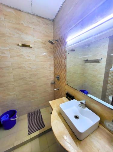 a bathroom with a sink and a mirror at Hotel Rivlet By Carlton Suites in Gurgaon