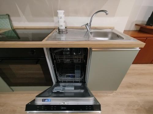 a microwave oven sitting in a kitchen next to a sink at Patecchio2-IEO Fondazione Prada Villaggio Olimpico in Vigentino