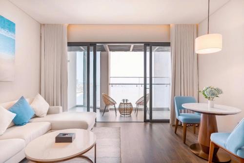 a living room with a couch and a table at OceanView Alacarte Hạ Long in Ha Long