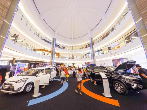 people looking at cars on display in a car show at Luxury Condominium at Loft Imago in Kota Kinabalu