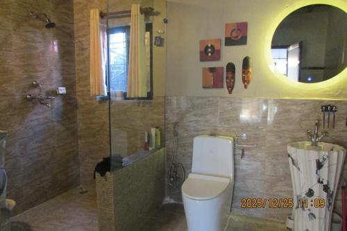 a bathroom with a toilet and a shower and a sink at BIG J'S Farm House in Dhulikhel