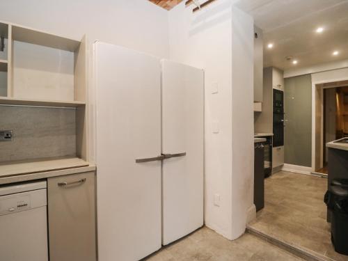 a kitchen with a white refrigerator in a room at Norwood House in Ambleside