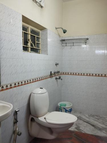 a bathroom with a toilet and a sink at Welcome Regency in kolkata