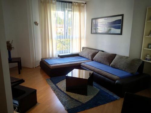 a living room with a couch and a table at Meri Apartment in Rijeka