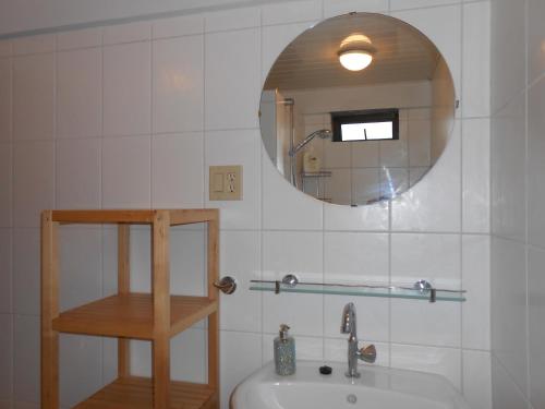 a bathroom with a sink and a mirror at Palm Village 134 in Paramaribo