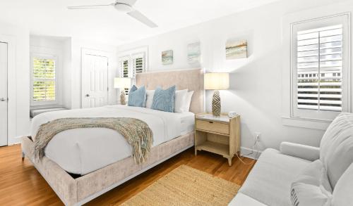 a white bedroom with a bed and a couch at Sugar in Santa Rosa Beach