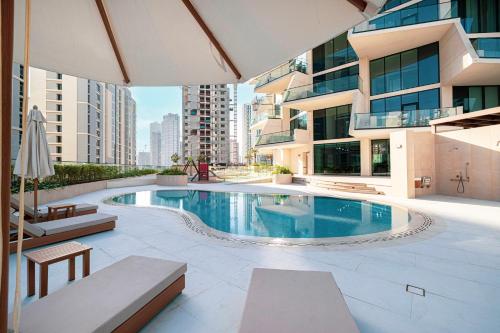 a swimming pool in the middle of a building at Iconic Binghatti Royale! Private Pool in Your Balcony! 5 Star Amenities! in Dubai